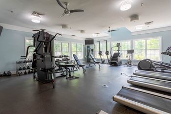 A spacious gym with treadmills, elliptical machines, and other exercise equipment.